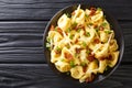 Tasty tortelloni with bacon and cheese close-up in a plate. horizontal top view