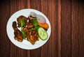 Tasty traditional fried chicken with healthy slad added in a plate