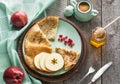 Tasty traditional russian breakfast of slapjack with honey on plate. Rustic style. Space for your text. Royalty Free Stock Photo