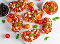 Tasty Traditional Tomato bruschetta with feta cheese topping, fresh basil.