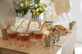 Tasty treats and glasses of drink on table in room. Sweet buffet Royalty Free Stock Photo