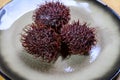 Tasty tropical exotic fruits, ripe fresh unpeeled hairy rambutan southeast Asian fruits rambutan southeast Asian fruits