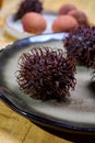 Tasty tropical exotic fruits, ripe fresh unpeeled hairy rambutan southeast Asian fruits rambutan southeast Asian fruits