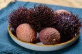 Tasty tropical exotic fruits, ripe fresh unpeeled lychee and hairy rambutan southeast Asian fruits