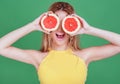 Tasty tropical fruits! Attractive sexual woman with beautiful makeup holding fresh juicy grapefruit or orange near face on isolate Royalty Free Stock Photo