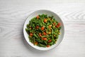 Tasty vegetable mix in bowl on white wooden table, top view Royalty Free Stock Photo