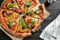 Tasty vegetable pizza on black wooden table Royalty Free Stock Photo