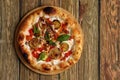 Tasty vegetarian pizza with vegetables, tomato souse, paper, cheese, herbs and basil. Traditional italy food on wooden