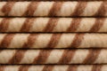 Tasty wafer roll sticks as background, top view. Royalty Free Stock Photo