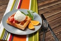 Tasty waffle with ice cream and fruits on plate Royalty Free Stock Photo