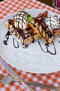 Tasty waffles with ice cream, strawberries and chocolate Royalty Free Stock Photo