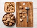 Tasty walnuts with hammer on wooden table Royalty Free Stock Photo