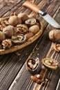 Tasty walnuts and knife on wooden table Royalty Free Stock Photo