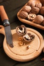 Tasty walnuts and knife on wooden table Royalty Free Stock Photo