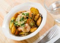 Tasty warm salad with fried potatoes, shrimp and mussels, served at plate Royalty Free Stock Photo