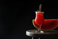 Tasty watermelon drink and fresh fruit on table against black background, space for text Royalty Free Stock Photo