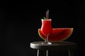 Tasty watermelon drink and fresh fruit on table against black background, space for text Royalty Free Stock Photo