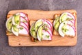 Tasty wheat toasts with radish, avocado and sprouts