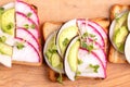 Tasty wheat toasts with radish, avocado and sprouts