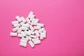 Tasty white chewing gums on pink background, flat lay. Space for text Royalty Free Stock Photo