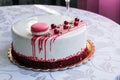 Tasty white homemade cake decorated by red berries and macaron