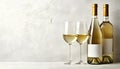 Tasty white wine in glasses and bottle on light grey background, space for text Royalty Free Stock Photo
