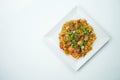 Tasty wok rice in sweet and sour sauce with vegetables and pork meat in a white plate on a gray background. Top view with copy Royalty Free Stock Photo