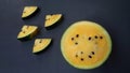 Tasty yellow watermelon over dark grey background