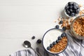 Tasty yogurt served with blueberries and muesli on white wooden table, flat lay. Space for text Royalty Free Stock Photo