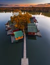 Tata, Hungary - Aerial view of beautiful autumn sunset over wooden fishing cottages on a small island at Lake Derito Derito-to