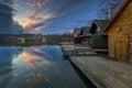 Tata, Hungary - Beautiful sunset over lake Derito Derito to in November with wooden fishing cottages Royalty Free Stock Photo