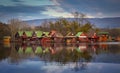 Tata, Hungary - Fishing cottages by the lake Derito on a small island at sunset with reflections