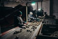 Tatarstan, Russia. 2022, June 14. Harvesting of potatoes. Sorting of earthy potatoes on a treadmill by farm workers