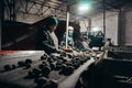 Tatarstan, Russia. 2022, June 14. Harvesting of potatoes. Sorting of earthy potatoes on a treadmill by farm workers