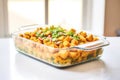 tater tot casserole in a glass baking dish