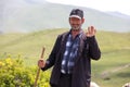 A friendly Armenian sheep herder waving hello.