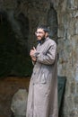 Tatev, Armenia - May 11, 2017. Monk in famous Tatev Monastery in mountains with funicular