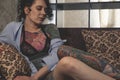 Tatoo girl on the sofa in home Royalty Free Stock Photo