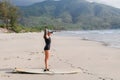 Tatoo woman with surfing board doing fitness