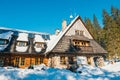 Group of tourists sit in front of a mountain hut and enjoy the sun, Koscieliska Valley Royalty Free Stock Photo