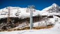 Skiers sitting at ski-lift chairs in resort Tatranska Lomnica, Slovakia