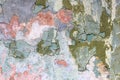 Tatter of a multi-colored old paint on a surface of a stone wall Royalty Free Stock Photo