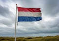 A tattered Dutch flag waves in the wind, featuring horizontal stripes Royalty Free Stock Photo