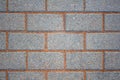 Tattered wall of gray blue bricks with red stone cement. rough surface texture Royalty Free Stock Photo