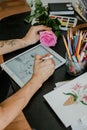 Tattoo art digital process on ipad. Tattoo artist working with Apple Pencil and drawing on iPad Pro in Procreate
