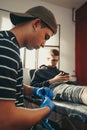 Tattoo artist choosing which needle to use for the job