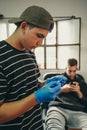 Tattoo artist choosing which needle to use for the job