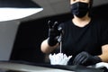 Tattoo artist holds cotton swabs in front of him with his fingers