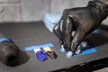 A tattoo artist is leaving some empty ink plastic cups on the work table. Close up