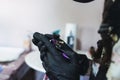 Tattoo artist wearing black sterile gloves and holding a tattoo pen Royalty Free Stock Photo